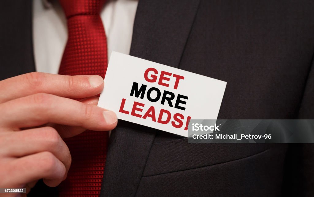 Businessman putting a card with text Get More Leads in the pocket Lead Stock Photo