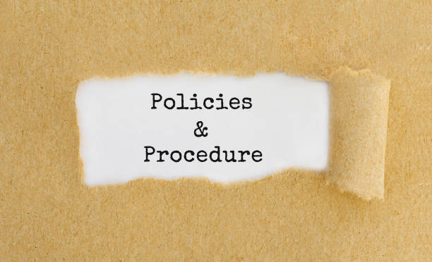 istock Text Policies and Procedure appearing behind ripped brown paper. 672308548