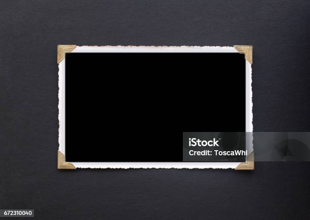 Photo Frame Real Old Photo With Black Blank Space For Copy Photo Pasted With Gold Coloured Photo Holder Corners Onto Black Vintage Album Paper Page Photograph Stock Photo - Download Image Now