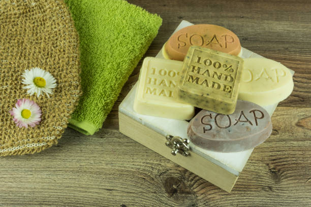 istock Various handmade soaps with many accessories on a wooden table 672312632