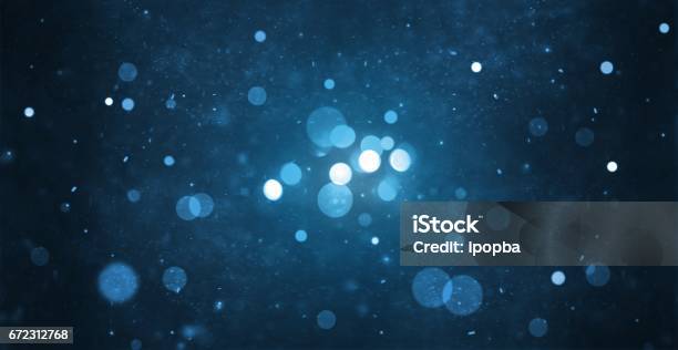 Abstract Particle Bokeh With Dark Blue Background Stock Photo - Download Image Now - Defocused, Blue, Illuminated