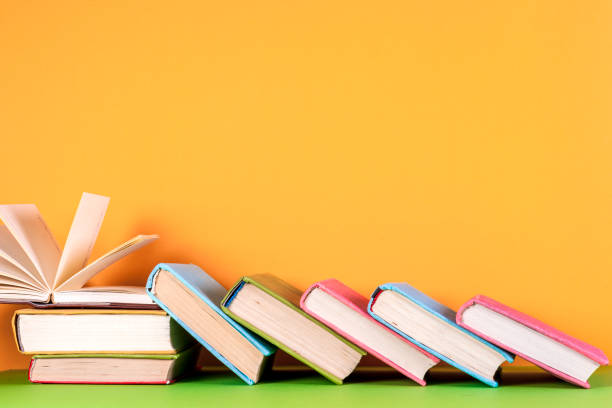istock Open book, hardback books on bright colorful background. 672313516