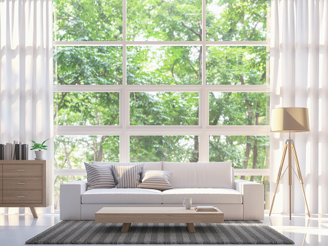 Modern white living room 3d rendering image.There are large window overlooking to nature and forest