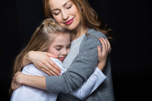 istock Mother and daughter embracing 672314866