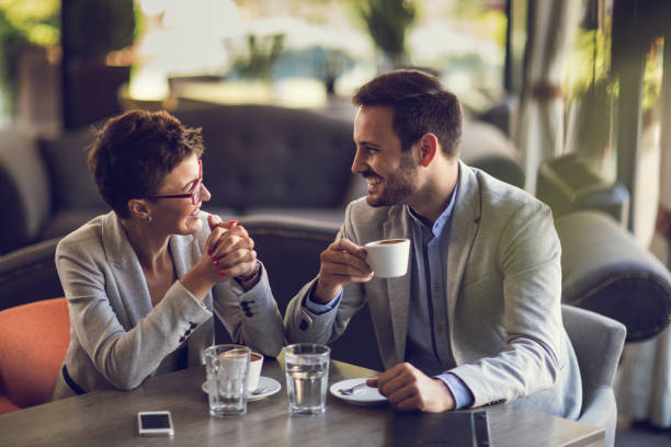 istock Young happy business couple communicating in a cafe. 672320154