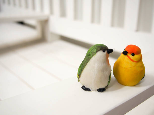 istock bird dolls made of stucco on white chair background 672320618