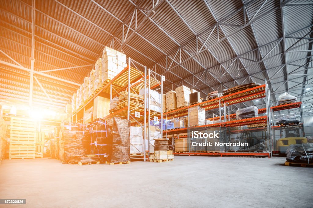 Large hangar warehouse industrial and logistics companies Large hangar warehouse industrial and logistics companies. Warehousing on the floor and called the high shelves. Toning the image. Warehouse Stock Photo