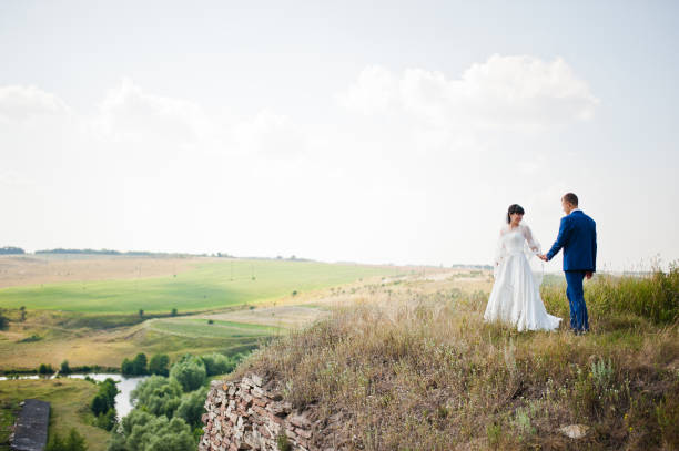 istock wedding couple near cliff 672320946