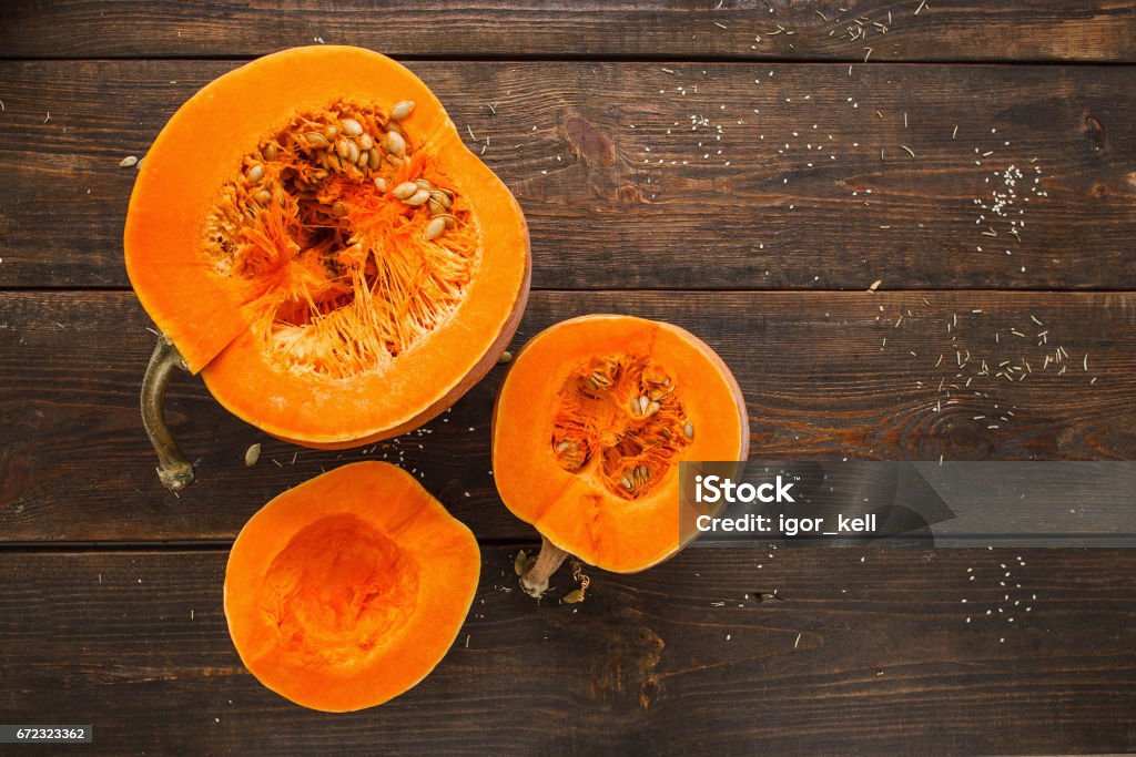 Set of orange pumpkins on wood flat lay free space Set of orange pumpkins on wood flat lay free space. Fresh cut squashes on wooden table, country autumn background. Seasonal, harvest, fall, organic food, dieting, healthy food concept Pumpkin Stock Photo