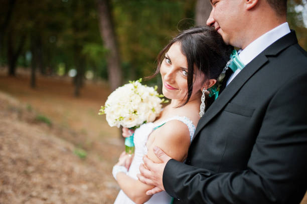 istock Newly wed in their wedding day at park 672324338