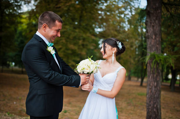 istock Newly wed in their wedding day at park 672324352
