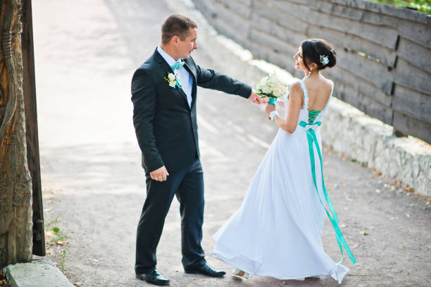 istock Newly wed in their wedding day at park 672324562