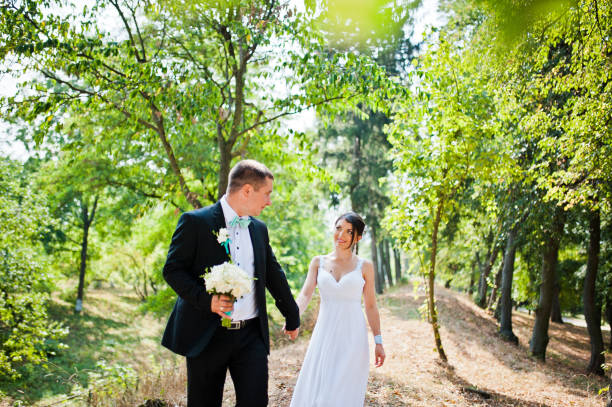 istock Newly wed in their wedding day at park 672324862