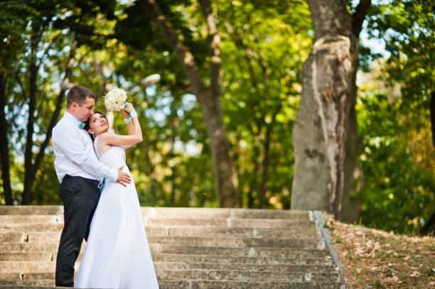istock Newly wed in their wedding day at park 672325210