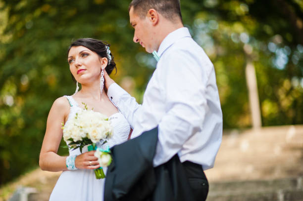 istock Newly wed in their wedding day at park 672325266