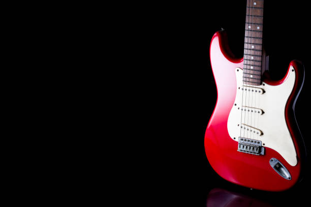istock Electric guitar on black background. Free space for text 672325496