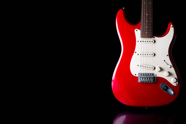 istock Electric guitar on black background. Free space for text 672325510