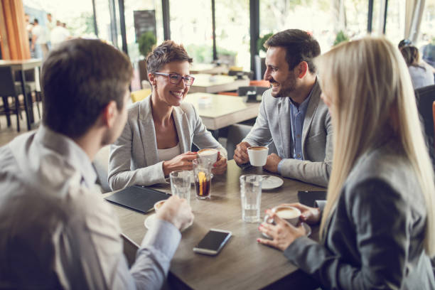 istock Happy business people enjoying in a cafe and talking. 672326266