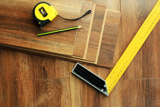 istock Laminate floor planks and tools on wooden background. Top view. 672330648
