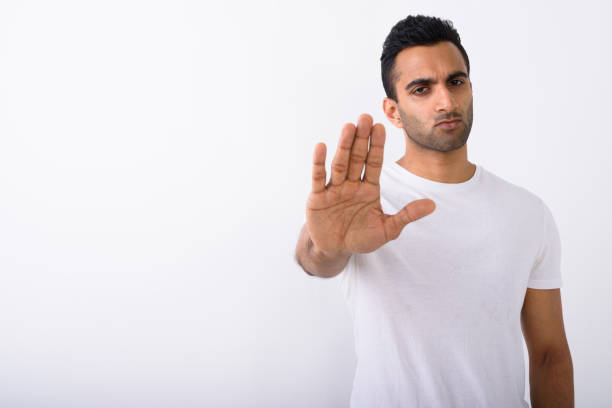 istock Studio shot of young handsome Indian man against white background 672331304