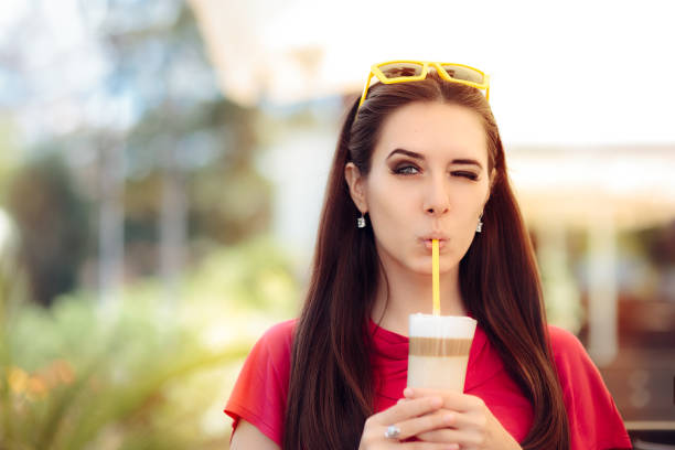istock Cool Girl Winking and Sipping Summer Coffee Drink 672331614
