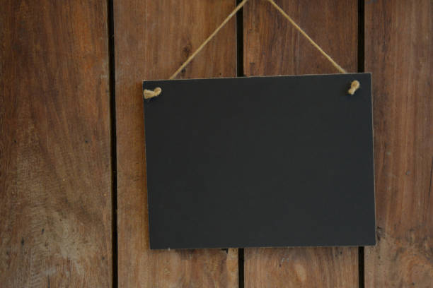 Blackboard sign on wooden background with copy space for advertising