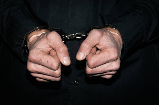 istock Hands of a criminal in handcuffs. 672339922