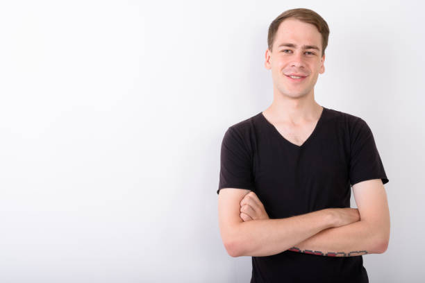 istock Studio shot of happy young man smiling against white background 672340508