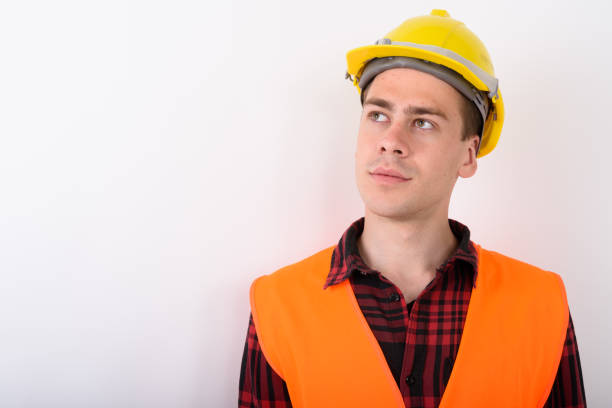 istock Close up of young man construction worker against white background 672342614