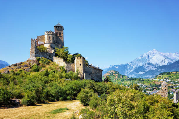 Ancient Valere Basilica on the hill at Sion, Canton Valais, Switzerland. Bernese Alps on the background