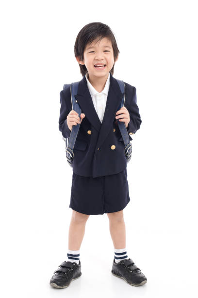 istock Asian child in school uniform with blue school bag 672343610