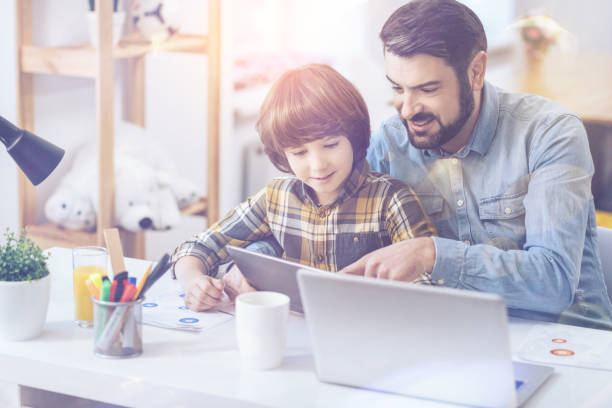 istock Father and son looking at digital tablet 672347118