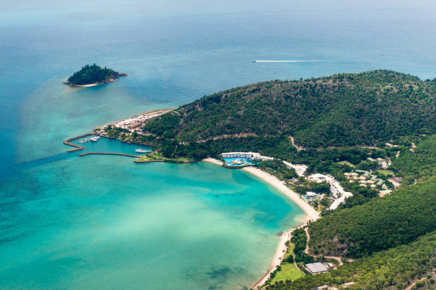 Superb panoramic view from the sea of the beautiful beach of Anse à l'Ane near the village of Trois-Ilets in Martinique facing the city of Fort-de-France.
