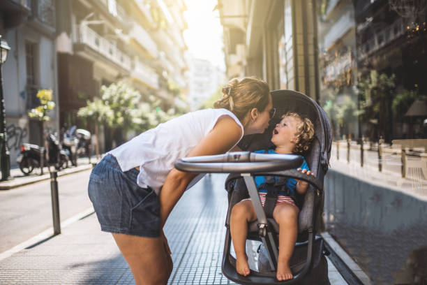 istock Mother with pram in city walk 672351120
