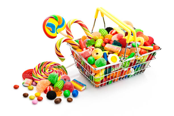 istock Shopping basket filled with colorful candies 672357456
