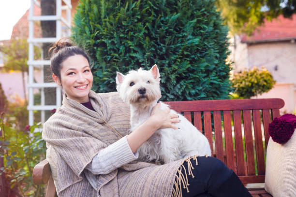 istock Beautiful young woman with dog 672357586