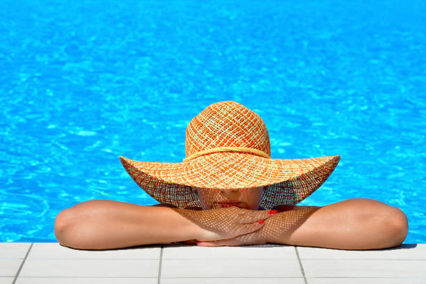 istock Real female beauty relaxing at swimming pool 672357968