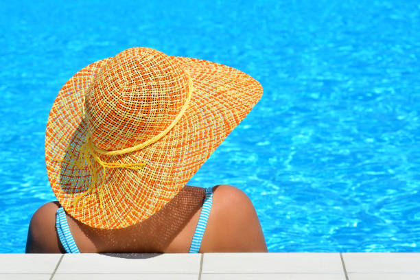 istock Real female beauty relaxing at swimming pool 672358792
