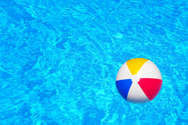 istock Colorful inflatable ball floating in swimming pool 672362502