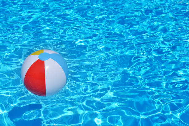istock Colorful inflatable ball floating in swimming pool 672362790
