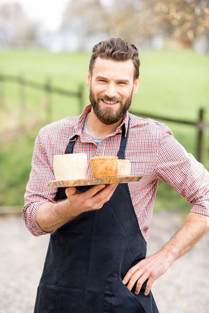 istock Farmer with cheese outdoors 672368722