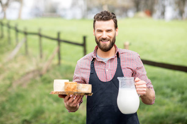 istock Farmer with cheese and milk 672368796