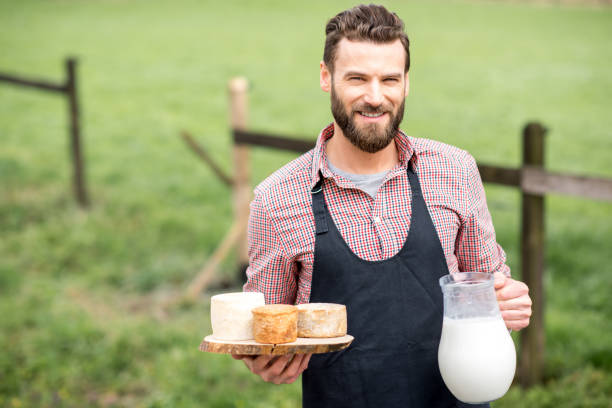 istock Farmer with cheese and milk 672368908