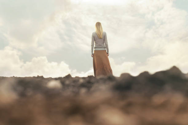 istock lonely woman walking towards infinity in a surreal place 672368956