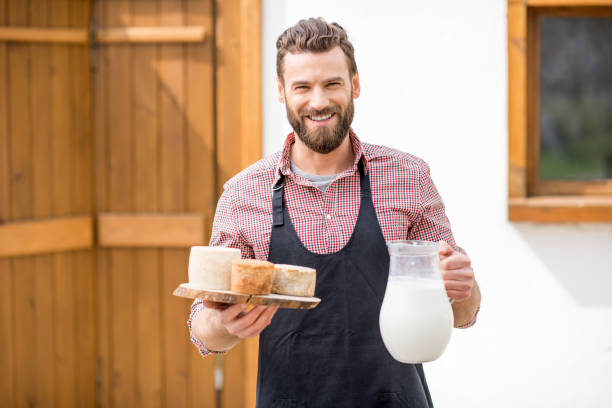 istock Farmer with milk and cheese outdoors 672369004