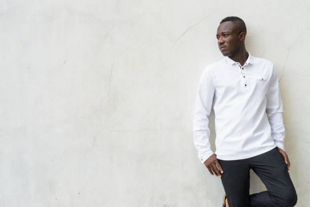 istock Young handsome African man against gray concrete wall 672369018