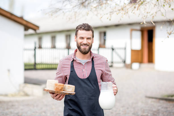 Farmer with milk and cheese outdoors