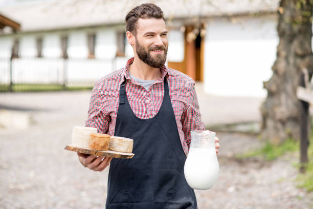 istock Farmer with milk and cheese outdoors 672369516