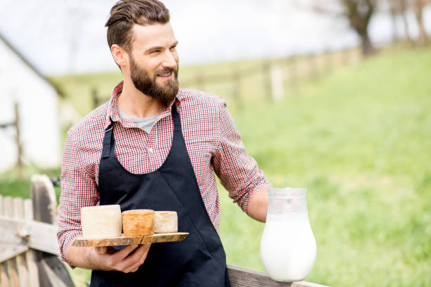 istock Farmer with cheese and milk 672369620