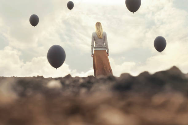 istock lonely woman walking towards infinity in a surreal place 672369742